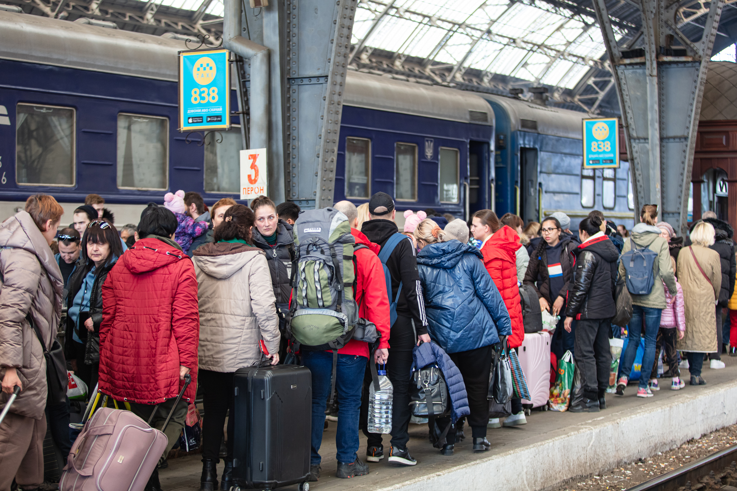 Ukrainian refugees on Lviv railway station waiting for train